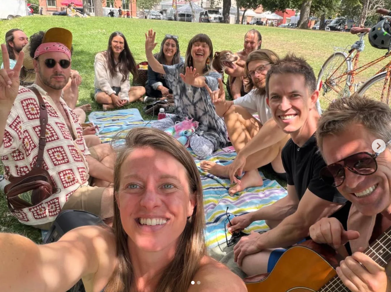 UR IN community relaxing together on blankets in the park